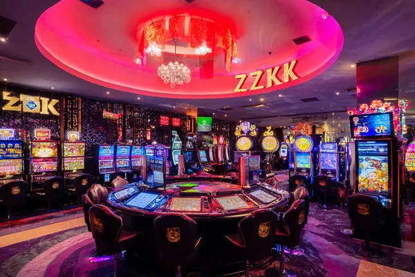 A woman in a luxurious green gown next to an ornate roulette wheel, capturing the upscale casino mood of 7D77.